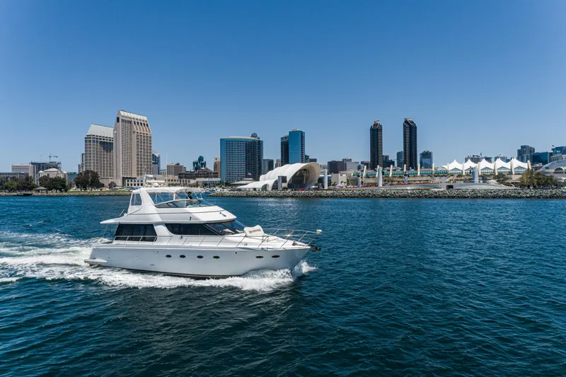 Slide: The Image of 1999 Carver 530 Voyager Pilothouse yacht cruising near city skyline. - 45