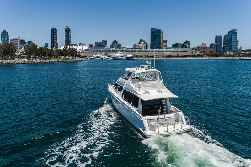 Slide: The Image of 1999 Carver 530 Voyager Pilothouse yacht cruising near city skyline. - 46