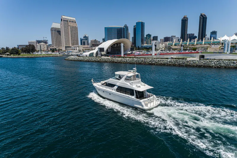 Slide: The Image of 1999 Carver 530 Voyager Pilothouse yacht cruising near city skyline. - 7