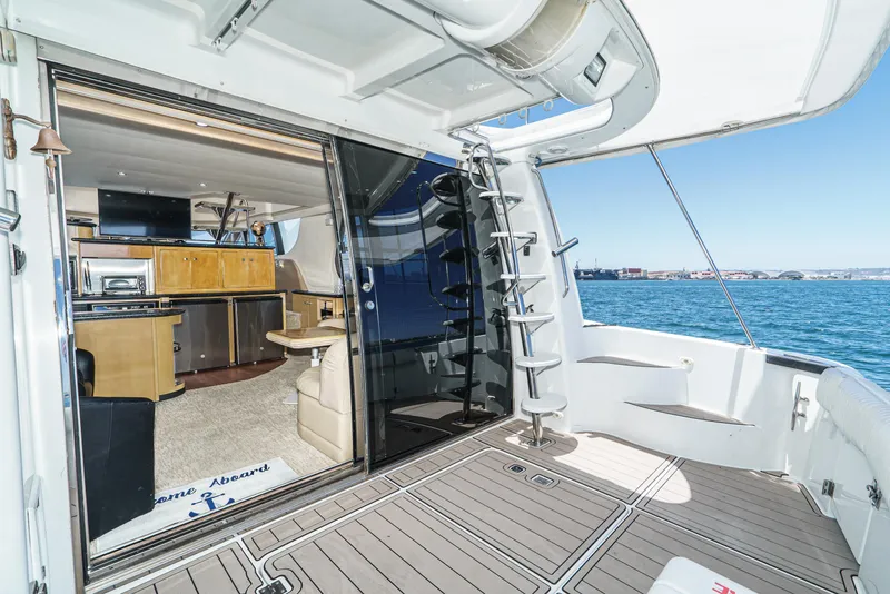 Slide: The Image of 1999 Carver 530 Voyager Pilothouse yacht interior with open deck and ocean view. - 8