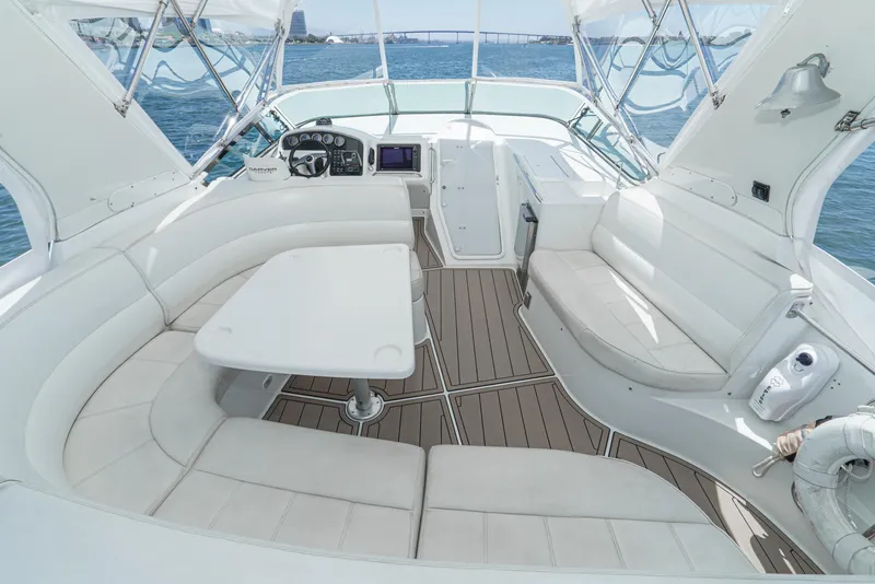 Slide: The Image of Luxurious 1999 Carver 530 Voyager Pilothouse interior with white seating and ocean view. - 9