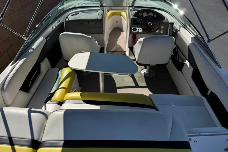 Slide: The Image of 2005 Regal 2200 Bowrider interior with seating, table, and steering wheel. - 10