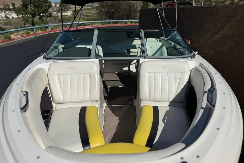 Slide: The Image of 2005 Regal 2200 Bowrider boat interior with white and yellow seating. - 11