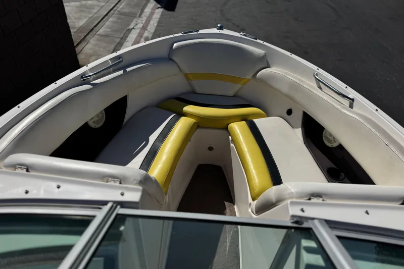 Slide: The Image of 2005 Regal 2200 Bowrider boat interior with yellow and white seating. - 12