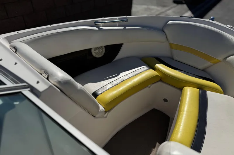Slide: The Image of 2005 Regal 2200 Bowrider interior with yellow and white seating, showcasing stylish design. - 13