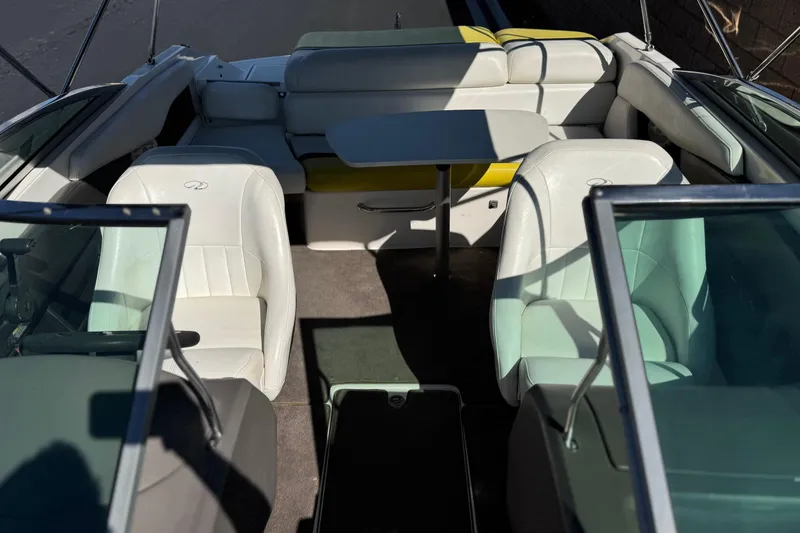 Slide: The Image of 2005 Regal 2200 Bowrider interior with white seating and a central table. - 16