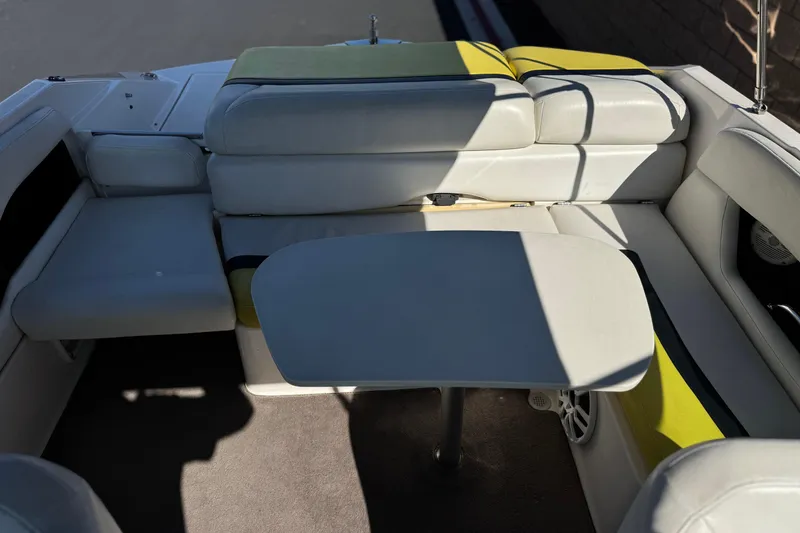 Slide: The Image of 2005 Regal 2200 Bowrider interior with cushioned seating and table. - 17