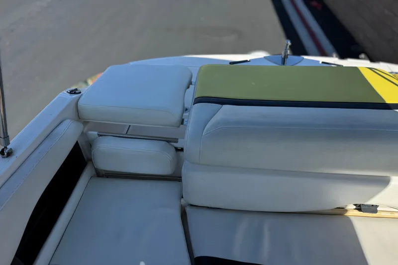 Slide: The Image of 2005 Regal 2200 Bowrider boat interior with white and yellow seating. - 20