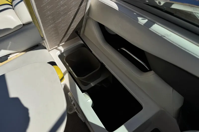 Slide: The Image of Interior storage compartment of a 2005 Regal 2200 Bowrider boat, featuring sleek design. - 23