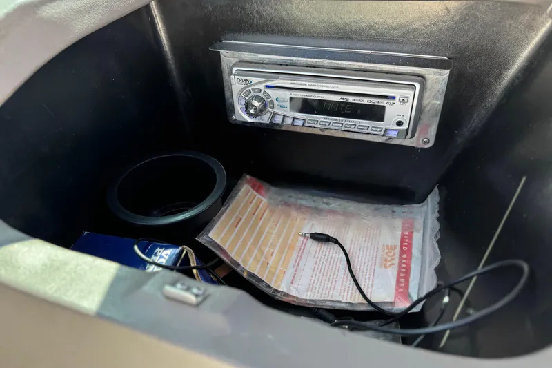 Slide: The Image of Glove compartment of 2005 Regal 2200 Bowrider with stereo system and documents. - 26