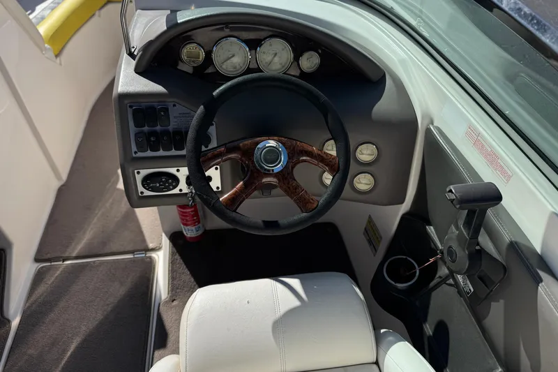 Slide: The Image of Interior view of 2005 Regal 2200 Bowrider boat dashboard with steering wheel and gauges. - 29