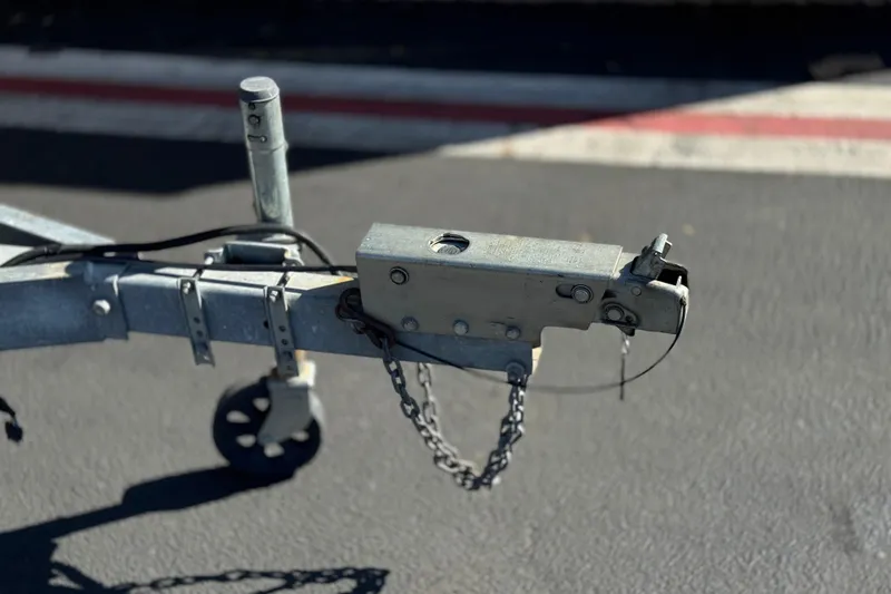 Slide: The Image of Trailer hitch of a 2005 Regal 2200 Bowrider on asphalt surface. - 31