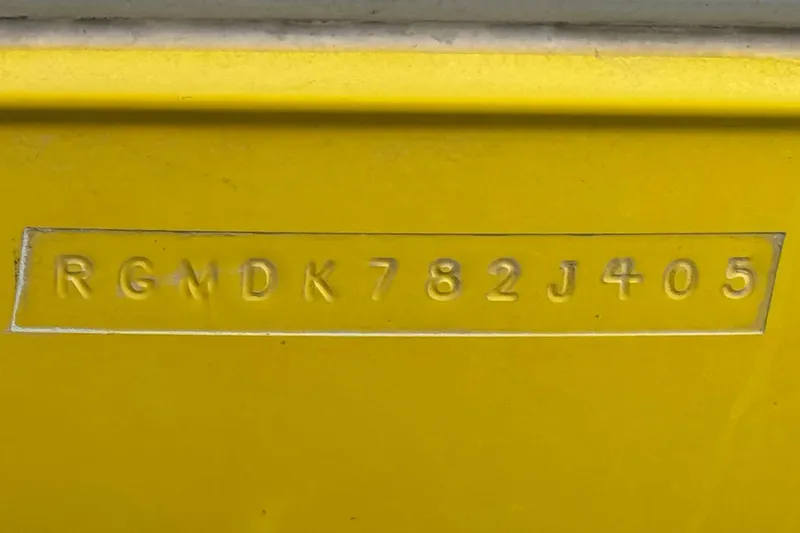 Slide: The Image of Hull identification number on yellow 2005 Regal 2200 Bowrider boat. - 33
