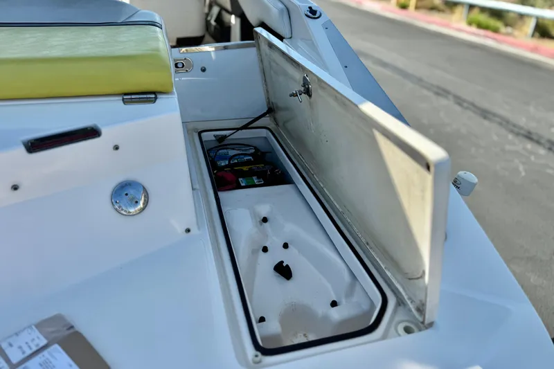 Slide: The Image of Open storage compartment on a 2005 Regal 2200 Bowrider boat, showing interior details. - 7