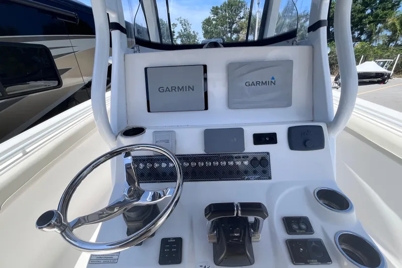 Slide: The Image of 2017 Tidewater 280 CC Adventure boat dashboard with Garmin navigation system. - 14