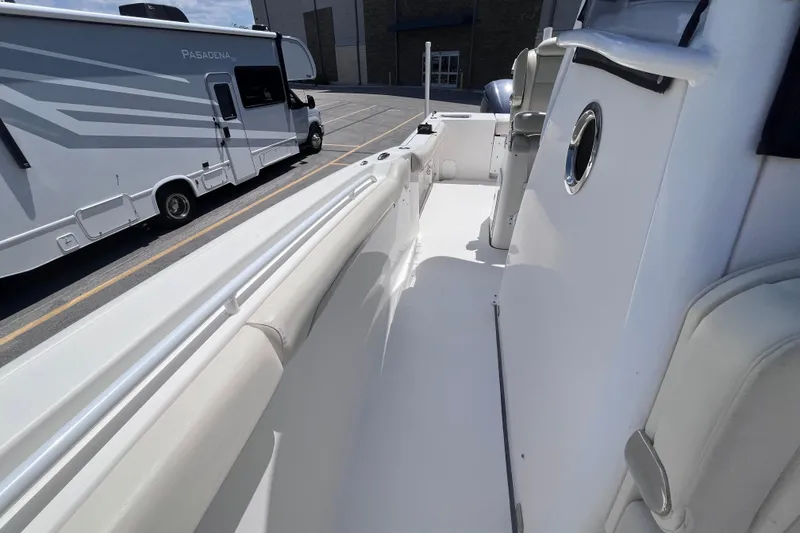 Slide: The Image of 2017 Tidewater 280 CC Adventure boat interior with RV in background. - 18