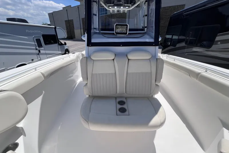Slide: The Image of 2017 Tidewater 280 CC Adventure boat interior with white seating and cup holders. - 19