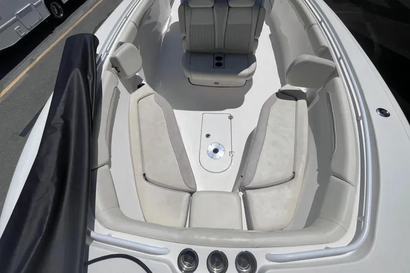 Slide: The Image of 2017 Tidewater 280 CC Adventure boat interior with cushioned seating and sleek design. - 20
