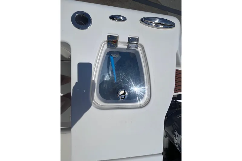 Slide: The Image of 2017 Tidewater 280 CC Adventure boat detail with hatch and cup holder. - 24