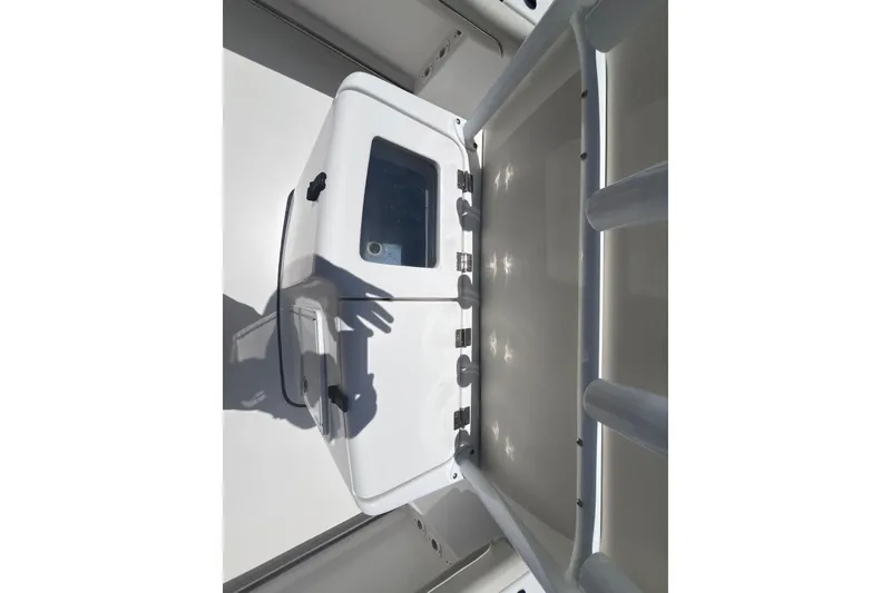 Slide: The Image of 2017 Tidewater 280 CC Adventure boat interior with storage compartment and sleek design. - 28