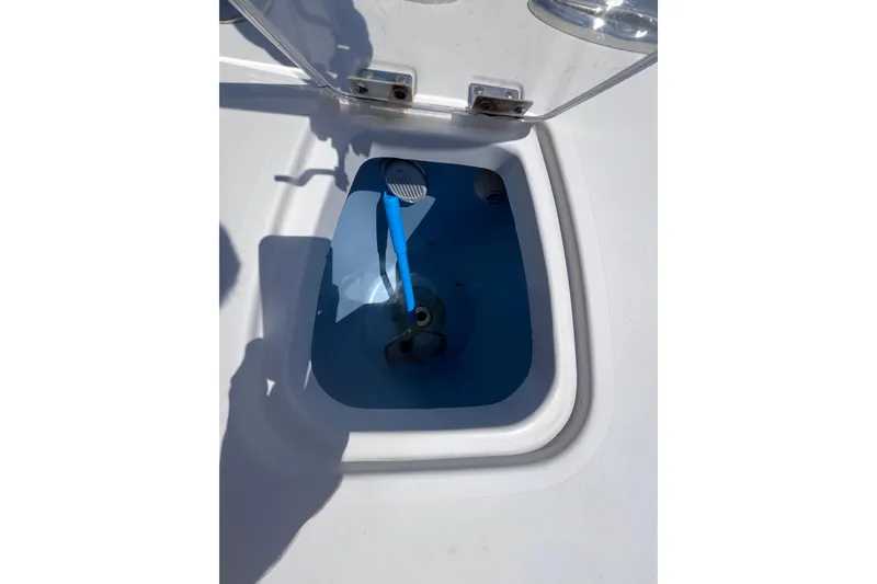 Slide: The Image of Open hatch on 2017 Tidewater 280 CC Adventure boat, showing interior compartment. - 29