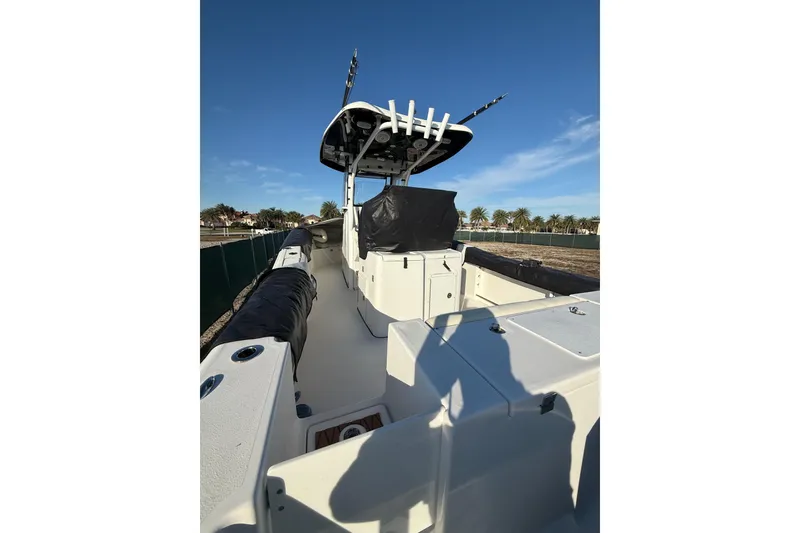 Slide: The Image of 2017 Tidewater 280 CC Adventure boat with T-top and fishing rod holders. - 3