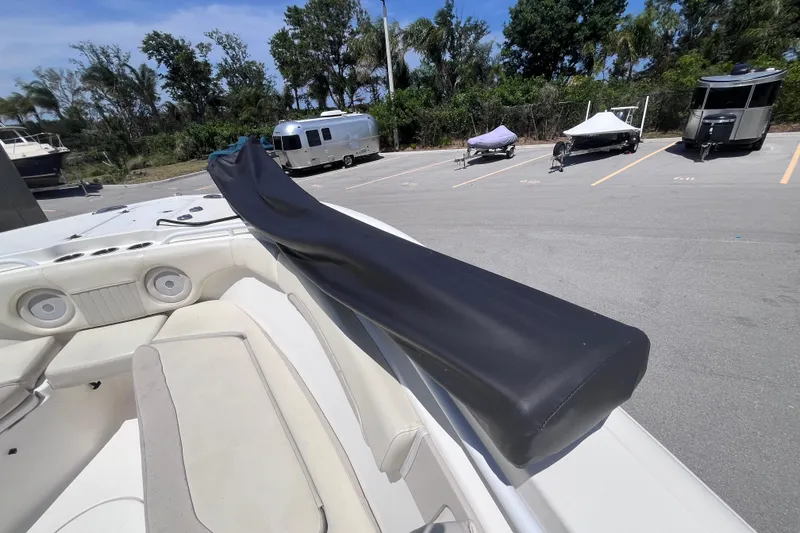 Slide: The Image of 2017 Tidewater 280 CC Adventure boat interior with covered equipment, parked trailers in background. - 31