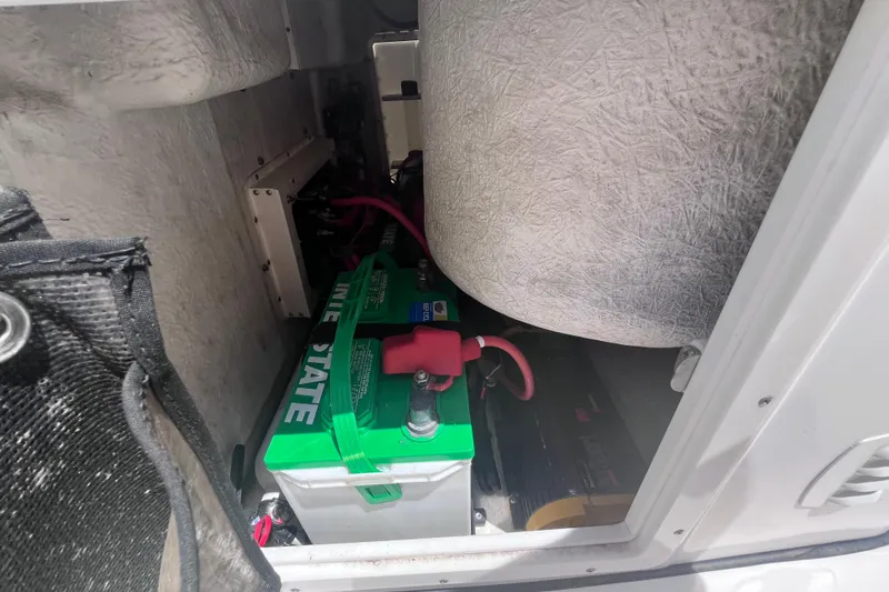 Slide: The Image of Battery compartment of a 2017 Tidewater 280 CC Adventure boat, featuring Interstate battery. - 37