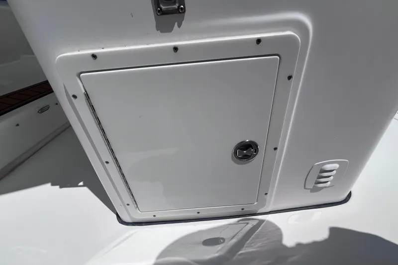 Slide: The Image of 2017 Tidewater 280 CC Adventure boat storage compartment with latch and vent. - 38