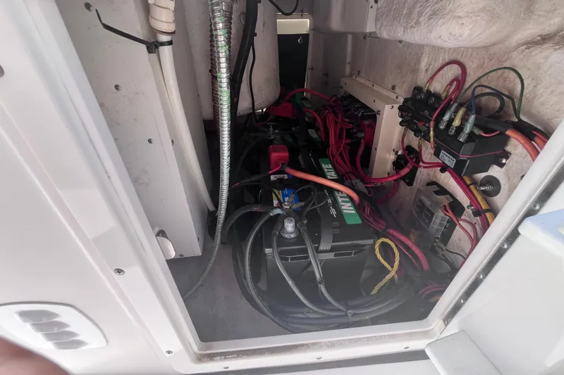 Slide: The Image of 2017 Tidewater 280 CC Adventure boat battery compartment with wiring and components. - 39