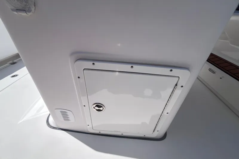 Slide: The Image of 2017 Tidewater 280 CC Adventure boat storage compartment with secure latch. - 40