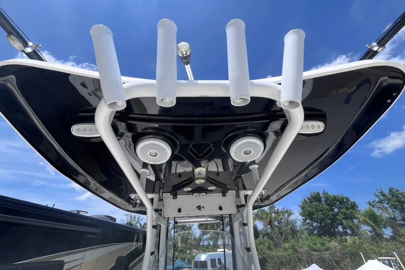 Slide: The Image of 2017 Tidewater 280 CC Adventure boat's T-top with rod holders and speakers. - 42