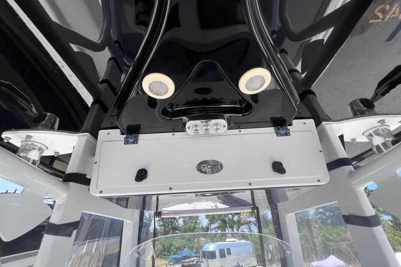 Slide: The Image of 2017 Tidewater 280 CC Adventure boat console with overhead lights and storage compartment. - 43
