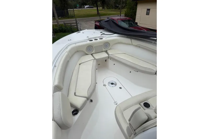 Slide: The Image of 2017 Tidewater 280 CC Adventure boat interior with white cushioned seating. - 8