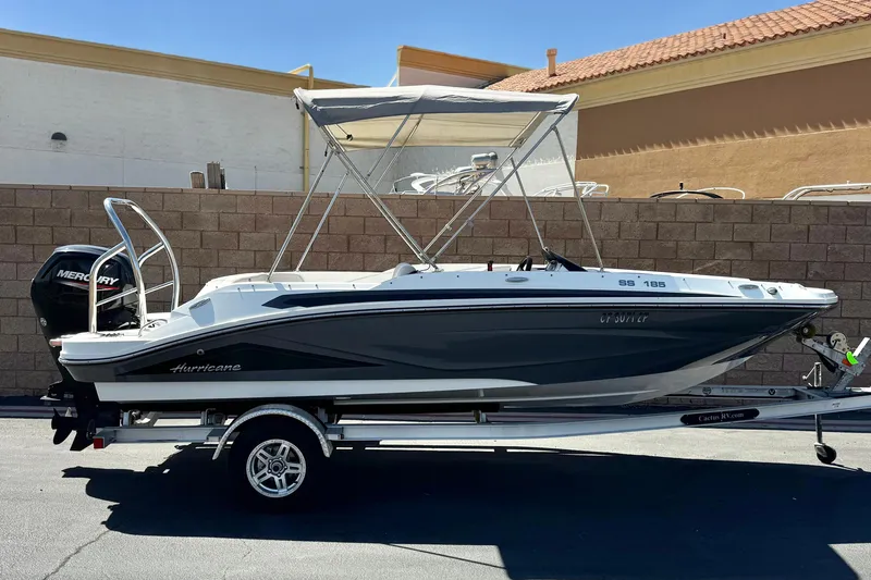 The Image of 2022 Hurricane SunDeck Sport 185 OB boat on trailer, parked outdoors. - 0