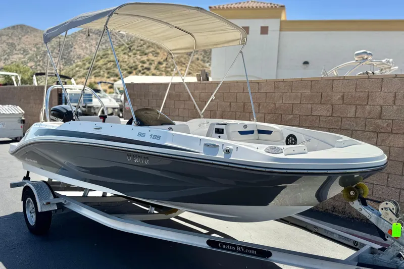Slide: The Image of 2022 Hurricane SunDeck Sport 185 OB boat on trailer, parked outdoors. - 1
