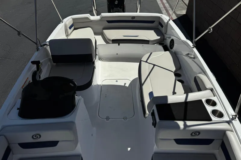 Slide: The Image of 2022 Hurricane SunDeck Sport 185 OB boat interior with seating and cup holders. - 14