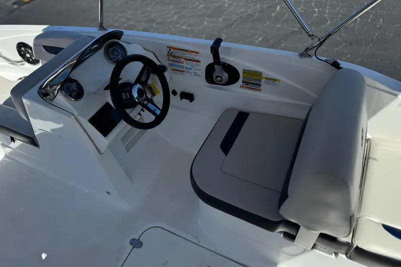 Slide: The Image of Cockpit view of 2022 Hurricane SunDeck Sport 185 OB boat with steering wheel and seating. - 22