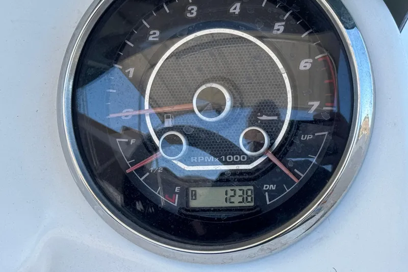 Slide: The Image of Close-up of a 2022 Hurricane SunDeck Sport 185 OB tachometer displaying 1238 RPM. - 24