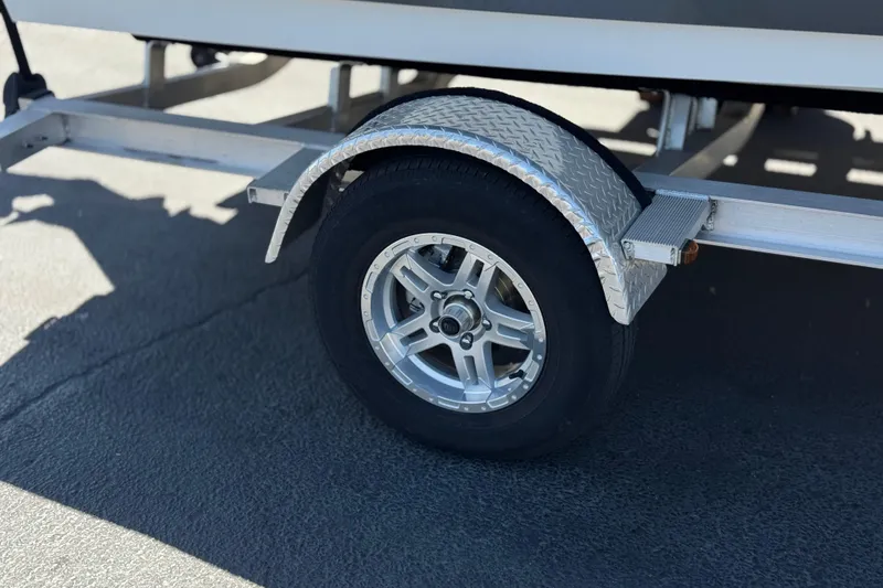 Slide: The Image of Trailer wheel of 2022 Hurricane SunDeck Sport 185 OB boat on pavement. - 25