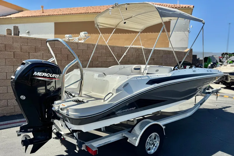 Slide: The Image of 2022 Hurricane SunDeck Sport 185 OB boat with Mercury outboard engine on trailer. - 5