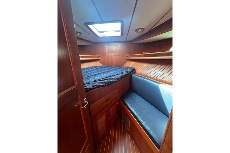 Slide: The Image of Cozy cabin interior of 2007 Heritage East Sundeck Trawler with wood paneling and skylight. - 17