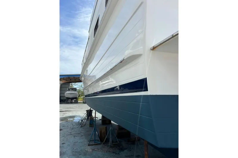 Slide: The Image of 2007 Heritage East Sundeck Trawler in dry dock, showcasing sleek hull design. - 26