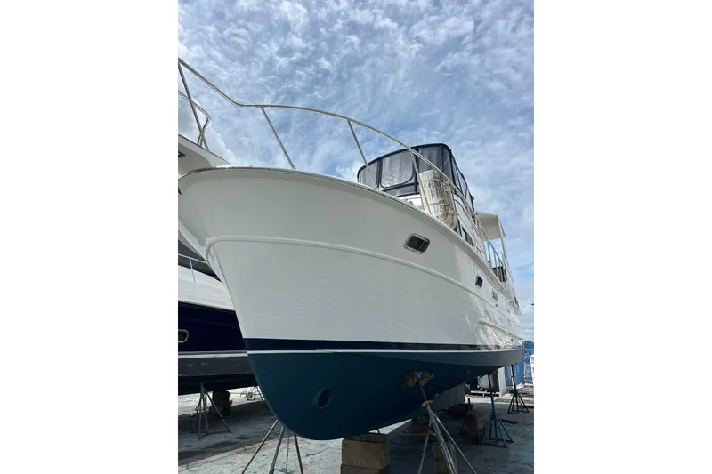 Slide: The Image of 2007 Heritage East Sundeck Trawler on dry dock under a partly cloudy sky. - 27