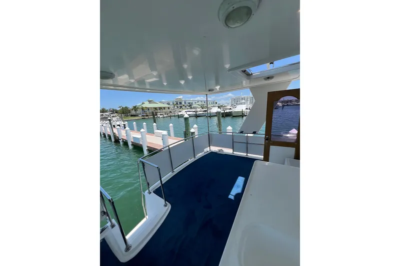Slide: The Image of 2007 Heritage East Sundeck Trawler docked at marina, featuring spacious deck and scenic waterfront view. - 3