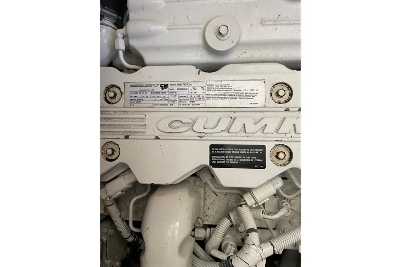 Slide: The Image of Engine detail of 2007 Heritage East Sundeck Trawler, featuring Cummins branding and specifications. - 30