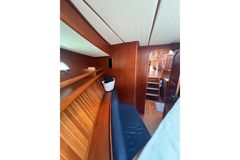 Slide: The Image of Interior of 2007 Heritage East Sundeck Trawler with wooden paneling and seating area. - 32