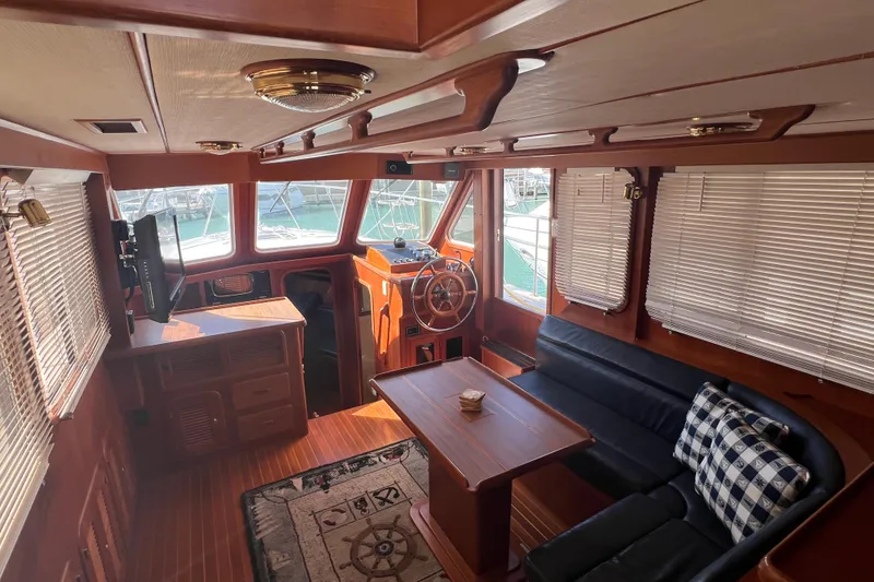Slide: The Image of Interior of 2007 Heritage East Sundeck Trawler with wood finish and nautical decor. - 7