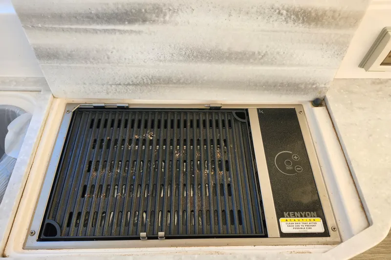 Slide: The Image of Built-in Kenyon grill on 2019 Regal 35 Sport Coupe yacht kitchen counter. - 11