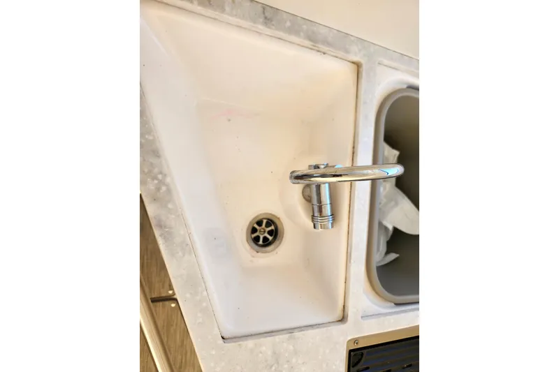 Slide: The Image of Sink and faucet in 2019 Regal 35 Sport Coupe boat kitchen area. - 13